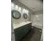 A modern bathroom with a double sink vanity with round mirrors and a bathtub is fresh and clean at , Durham, NC 27712