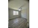 Neutral bedroom featuring wood-look floors, ceiling fan and a bright, sunlit window at , Durham, NC 27712