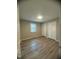 Bright bedroom with wood-look flooring and double closets featuring fresh neutral paint throughout at , Durham, NC 27712