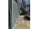 Exterior of the house with a grey brick wall, long driveway, and a car parked at , Durham, NC 27712