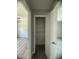 Neutral hallway featuring wood-look floors and a glimpse of a spare, sunlit, living room at , Durham, NC 27712