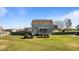 Landscaped backyard featuring a covered patio, lush lawn, and wooden privacy fence at 1036 Butterfly Cir, Wake Forest, NC 27587