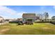 Spacious backyard featuring a well-maintained lawn, mature trees, and a patio area at 1036 Butterfly Cir, Wake Forest, NC 27587