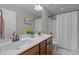 Bathroom with a double sink vanity and a shower with a curtain at 1036 Butterfly Cir, Wake Forest, NC 27587