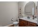 Tastefully designed half-bathroom with dark wood vanity, framed mirror, and updated lighting at 1036 Butterfly Cir, Wake Forest, NC 27587