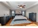 Inviting main bedroom featuring hardwood floors, tray ceiling, and neutral color palette at 1036 Butterfly Cir, Wake Forest, NC 27587