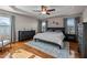 Main bedroom featuring hardwood floors, tray ceiling, and large windows for natural light at 1036 Butterfly Cir, Wake Forest, NC 27587