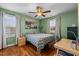 Bedroom with green walls, hardwood floors, and a ceiling fan at 1036 Butterfly Cir, Wake Forest, NC 27587