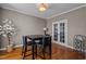 Cozy dining area with dark wood floors and a view to the adjacent room through glass French doors at 1036 Butterfly Cir, Wake Forest, NC 27587