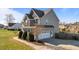 Two-story home with a stone facade and a three-car garage at 1036 Butterfly Cir, Wake Forest, NC 27587
