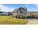 Landscaped yard showcasing a well-maintained lawn, mature trees, and a gray two-story home at 1036 Butterfly Cir, Wake Forest, NC 27587