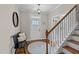 Bright foyer with hardwood floors, stylish mirror, bench, and staircase creating a welcoming entrance at 1036 Butterfly Cir, Wake Forest, NC 27587