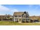 Charming two-story home featuring gray siding, stone accents, and a well-manicured lawn at 1036 Butterfly Cir, Wake Forest, NC 27587