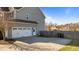 A two-car garage with an adjacent service door and large driveway at 1036 Butterfly Cir, Wake Forest, NC 27587