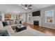 Inviting living room with hardwood floors, a cozy fireplace, and open access to a modern kitchen at 1036 Butterfly Cir, Wake Forest, NC 27587
