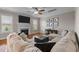 Comfortable living room with fireplace, TV, hardwood floors, and large sectional couch, a great space to relax at 1036 Butterfly Cir, Wake Forest, NC 27587