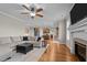Spacious living room with hardwood floors, fireplace, TV, and open access to a modern kitchen at 1036 Butterfly Cir, Wake Forest, NC 27587