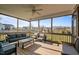 Relaxing screened-in patio featuring wood floors and comfortable seating with a lovely view of the neighborhood at 1036 Butterfly Cir, Wake Forest, NC 27587