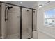 Tiled shower with a sleek black frame, built-in bench, and a matte black shower head at 1036 Butterfly Cir, Wake Forest, NC 27587
