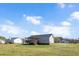 Back exterior of home with a covered back deck and large yard at 105 Seminole Dr, Wendell, NC 27591