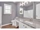 Bathroom with granite counters, grey paint, and a large framed mirror at 105 Seminole Dr, Wendell, NC 27591
