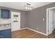 Cozy dining area with modern light fixture, wood-look floors, and access to the kitchen and backyard at 105 Seminole Dr, Wendell, NC 27591