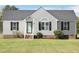 Charming single-story home with light siding, black shutters, and a well-manicured front lawn at 105 Seminole Dr, Wendell, NC 27591
