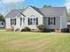 Beautifully maintained home with light siding, black shutters, complemented by a lush green lawn at 105 Seminole Dr, Wendell, NC 27591
