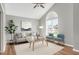 Bright living room featuring a vaulted ceiling, large arched window, and stylish contemporary furnishings at 105 Seminole Dr, Wendell, NC 27591