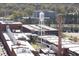 Aerial view of the Lucky Strike water tower and smokestack amidst downtown buildings and lush greenery at 110 N Corcoran St # 2302, Durham, NC 27701