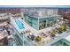 Stunning aerial view of the rooftop amenities including a pool, lounge area, and cityscape at 110 N Corcoran St # 2302, Durham, NC 27701