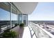 Spacious balcony with glass railing and city views, featuring patio seating and planters at 110 N Corcoran St # 2302, Durham, NC 27701