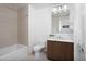 Bright bathroom featuring tile flooring, modern vanity with white countertop, and shower and tub combo at 110 N Corcoran St # 2302, Durham, NC 27701