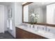 Contemporary bathroom with double vanity, marble countertop, and a large mirror reflecting natural light at 110 N Corcoran St # 2302, Durham, NC 27701