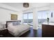 Bright bedroom featuring a bed, dark hardwood floors, and cityscape views at 110 N Corcoran St # 2302, Durham, NC 27701