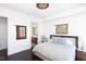 Sleek, modern bedroom with unique wall art, an elegant chandelier, and doorway leading to a bath at 110 N Corcoran St # 2302, Durham, NC 27701