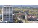 An urban cityscape view showing the NC Mutual Life building, churches, and colorful spring trees at 110 N Corcoran St # 2302, Durham, NC 27701
