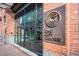 The building entrance features a modern glass facade and signage, providing easy access and a professional image at 110 N Corcoran St # 2302, Durham, NC 27701