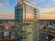 Stunning glass high-rise exterior reflecting the sunset, showcasing its modern design and city views at 110 N Corcoran St # 2302, Durham, NC 27701