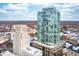 A modern high-rise stands tall, complemented by the surrounding city landscape and a clear blue sky at 110 N Corcoran St # 2302, Durham, NC 27701