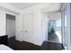 Hallway leading to balcony featuring sliding glass doors with scenic city views and bright natural light at 110 N Corcoran St # 2302, Durham, NC 27701