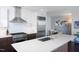 Open kitchen featuring stainless steel appliances, a large island, and modern finishes at 110 N Corcoran St # 2302, Durham, NC 27701
