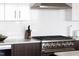 Modern kitchen with stainless steel appliances, white cabinets and tile backsplash at 110 N Corcoran St # 2302, Durham, NC 27701