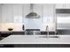 Bright kitchen with stainless appliances, white cabinets, subway tile, and large island at 110 N Corcoran St # 2302, Durham, NC 27701