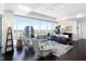 Stylish living area with floor-to-ceiling windows, comfortable seating, and an open layout to the outside balcony at 110 N Corcoran St # 2302, Durham, NC 27701