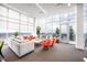 Modern resident lounge with expansive windows offering panoramic city views, comfortable seating, and natural light at 110 N Corcoran St # 2302, Durham, NC 27701