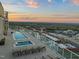 Relaxing rooftop pool and lounge area offering stunning views of the city skyline at 110 N Corcoran St # 2302, Durham, NC 27701
