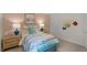Comfortable bedroom featuring a colorful bedspread, matching nightstands with lamps, and charming wall decor at 1104 Ursa Major Ct, Wendell, NC 27591