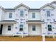 New townhome exterior featuring white siding, black roof, and construction wrap on windows before completion at 1105 Brookrun Dr, Oxford, NC 27565