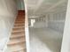 Open concept living room with stairs, and rough drywall before final finishes, showing layout and potential at 1105 Brookrun Dr, Oxford, NC 27565